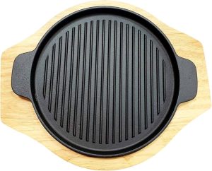 Image-15-1.jpeg Cast iron sizzling grill pan with dual handles and a wooden serving base